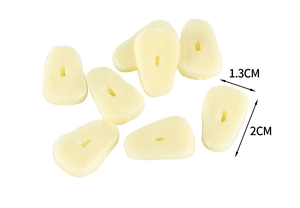 Macro detail of miniature 2cm PVC garlic slices for dollhouse DIY food accessory