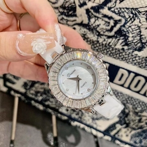 Elegant white ceramic watch with diamond bezel and mother-of-pearl dial on a luxury background
