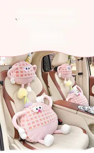 Detailed texture of pink lamb wool car headrest with cute cartoon monster design