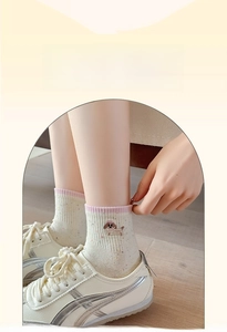 Close-up of cute cartoon puppy embroidery on soft cream knit socks for women