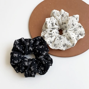 Chic black and white polka dot scrunchies with bow print on premium textured fabric
