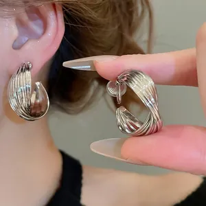 Minimalist silver twisted ribbed hoop earrings for women with high polish finish
