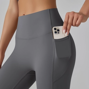 Close-up of high waist yoga leggings showing functional side pocket with a smartphone