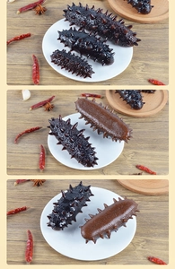 Realistic artificial sea cucumber models for display with kitchen props on wooden background