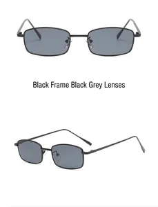 Detail view of narrow black rectangular metal frame sunglasses with dark grey lenses