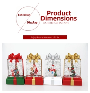 Detailed view of four festive Christmas glitter globes with Santa and snowman figurines