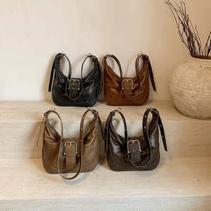 Retro matte leather underarm bags with vintage buckles in four colors on stone steps