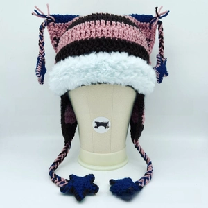 Detail of knit cat ear hat with pink stripes and white faux fur trim and tassels