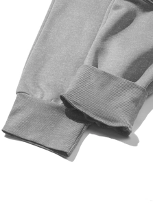 Detail of high-density ribbed cuff on grey fleece joggers showing knit fabric texture