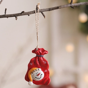 Christmas tree resin ornament featuring a red snowman gift bag with Let It Snow text