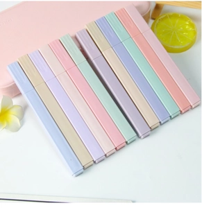 Macro view of 12-piece pastel square highlighters on a decorative desktop setup