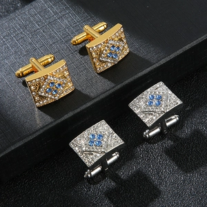 Elegant rectangle cufflinks with crystals in gold and silver finish on dark background