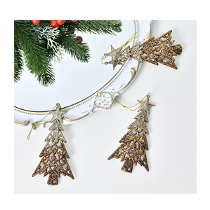 Detail of three glittered Christmas tree ornaments with gold gradient finish and hanging cords