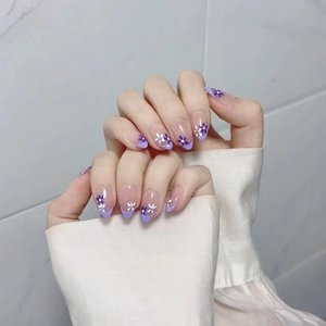 Violet French press-on nails with delicate hand-painted floral patterns in almond shape