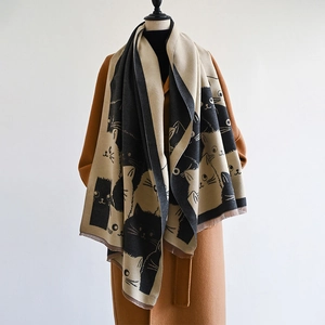 Close-up of cute cat pattern on thick bicolor beige and black cashmere shawl scarf
