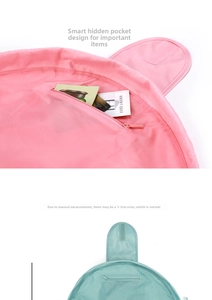Detail view of pink and blue waterproof drawstring makeup bag with inner zipper pocket