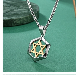 Macro shot of silver octagonal pendant with gold Star of David on marble background