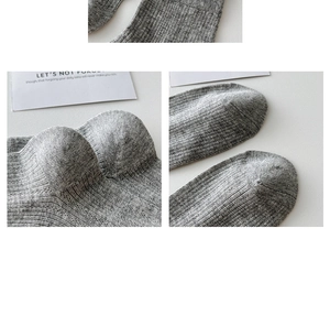 Close-up of reinforced heel and toe on grey melange knit breathable cotton socks