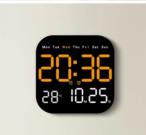 Detail of black digital clock showing orange LED time, date, temperature and weekday display