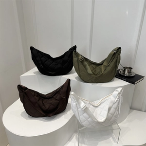 Quilted nylon crescent bags in black, olive, coffee, and white on geometric stands