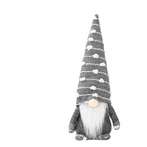 Handcrafted Christmas gnome with knitted hat and long white beard for holiday decoration