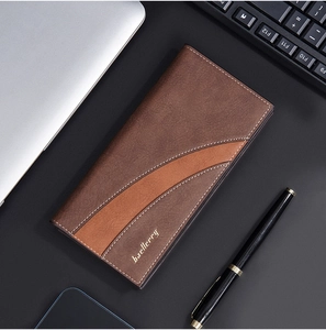 Brown long leather business wallet for men on a professional office desk background