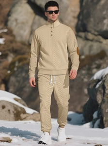 Detailed knit texture of beige stand collar sweater and matching joggers on model