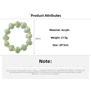 Green acrylic beaded bracelet with gold spacers and irregular oval beads detail