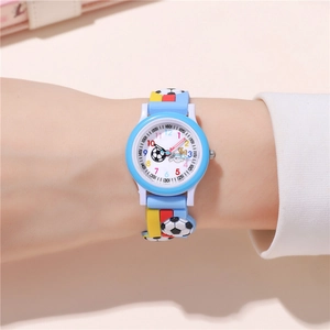 Detail of soccer-themed kids quartz watch with 3D football strap on a child's wrist