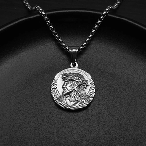 Macro view of vintage silver steel medallion pendant featuring detailed Ecce Homo relief
