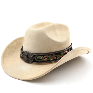 Close-up of beige western cowboy hat featuring ethnic embroidery and metallic emblem