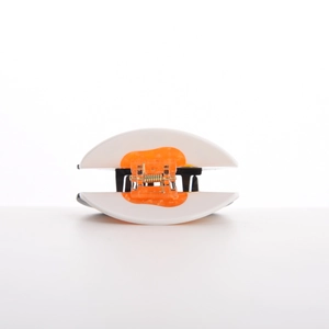 Detail of creative sushi hair claw clip with white shell and orange spring mechanism