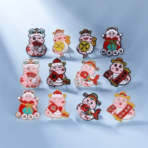 Detailed grid of 12 cute enamel snake pins with Chinese New Year festive symbols