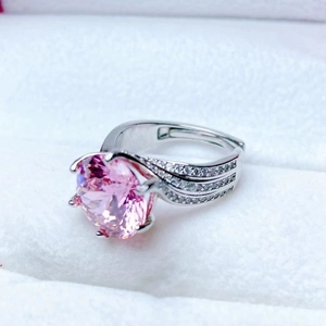 Macro shot of pink heart-and-arrow zircon ring with six-prong crown setting