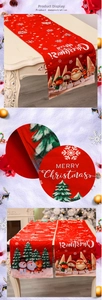 Detail of red Christmas table runner with Santa Claus, reindeer prints and festive text