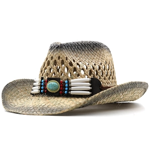 Detail of straw cowboy hat featuring turquoise stone and ethnic beadwork on black band
