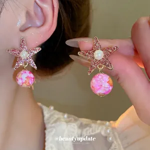 Star-shaped pink crystal earrings with white faux pearl and marble texture drop beads