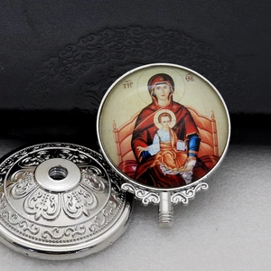 Detail of silver religious metal icon with Virgin and Child under glass cover
