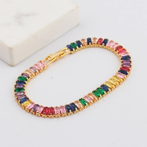 Detail of colorful rectangular zirconia stones on a gold-plated double-row bracelet