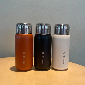 Three 316 stainless steel vacuum flasks in orange black and white with silver lids