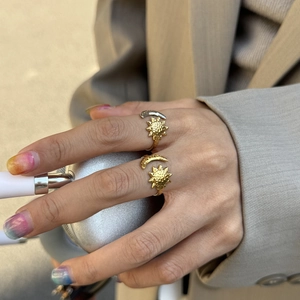 Detail of 18K gold plated sun and moon rings with hammered texture and open adjustable band