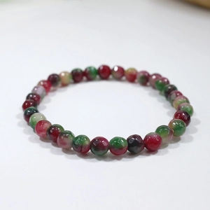Close-up of multicolored faceted beads on a natural gemstone elastic bracelet