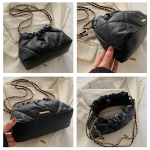 Detailed views of a black quilted bucket bag featuring a gold-tone chain and cinch closure