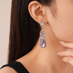 Macro detail of teardrop purple gemstone earring with sparkling zircon insets
