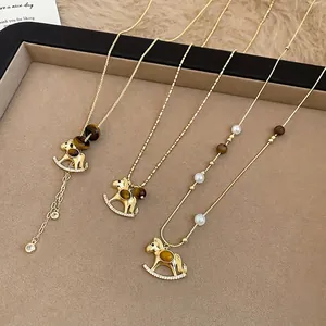Elegant rocking horse necklace with tiger eye stone and pearls on gold chain