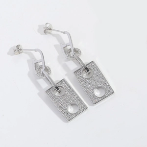 Macro detail of silver rectangular drop earrings with micro-pave white zircon crystals