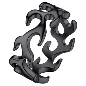 Detail showing matte black stainless steel ring with hollow flame pattern engraving