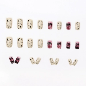 24-piece set of square-oval fake nails with black speckle pattern and graffiti text designs