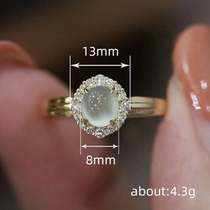 Moonstone gold ring with a halo of white diamonds, 13mm diameter and 8mm width