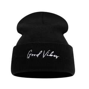 Classic black knitted beanie featuring white Good Vibes embroidery on a folded cuff